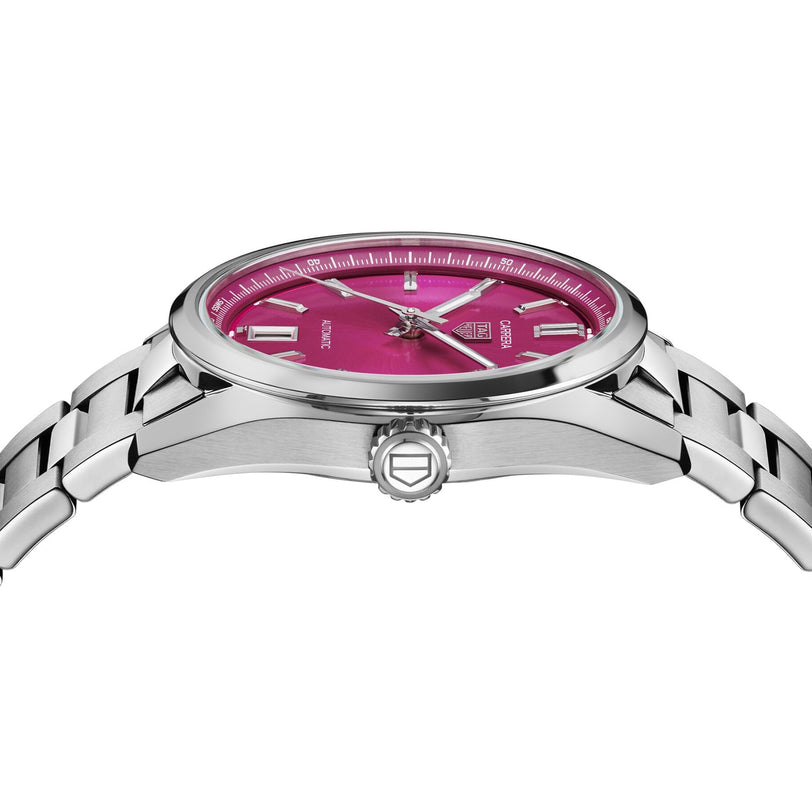 The TAG Heuer Carrera Date wristwatch features a stainless steel case, metallic bracelet, and pink dial. Shown in side view, it highlights the profile, detailed crown, and automatic movement for lasting style.