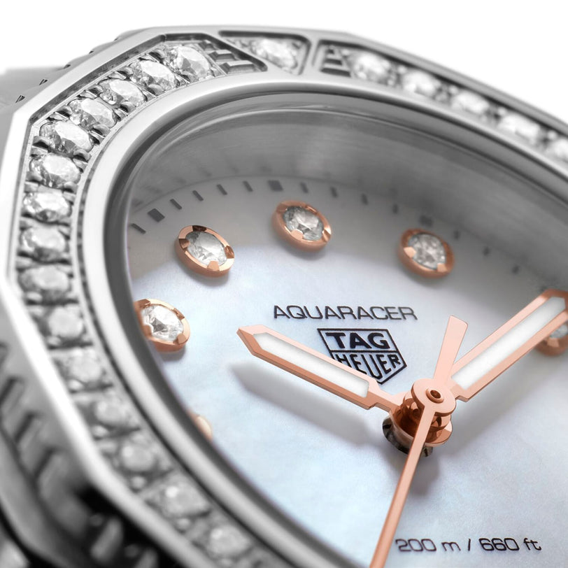 Close-up of the TAG Heuer Aquaracer Professional 200, featuring diamond hour markers, a lustrous mother-of-pearl dial, rose gold hands, and a dazzling diamond-set bezel.
