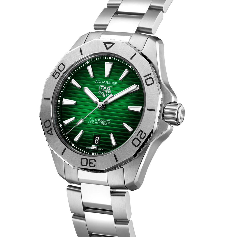 The TAG Heuer Aquaracer Professional 200 is a sports watch featuring a green dial, silver hour markers, date at 6 o’clock, and a stainless steel case with matching bracelet.