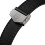 Close-up of a black textured strap with a matte silver clasp engraved with the TAG Heuer shield, designed to complement the Monaco Chronograph and its striking skeletonised dial.