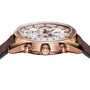 A close-up side view of the TAG Heuer Special Edition Carrera Chronosprint x Porsche watch in rose gold with a white dial, two pushers, automatic chronograph movement, and a brown leather strap showcasing intricate face details.
