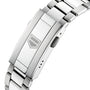Close-up of a stainless steel TAG Heuer Aquaracer 200 Professional Solargraph watch bracelet clasp featuring an engraved geometric logo on the flat surface.
