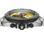 Close-up side view of the TAG Heuer Formula 1 Chronograph, featuring a stainless steel case, yellow and black dial, two push buttons, crown, and metal bracelet—an iconic design inspired by motor racing.