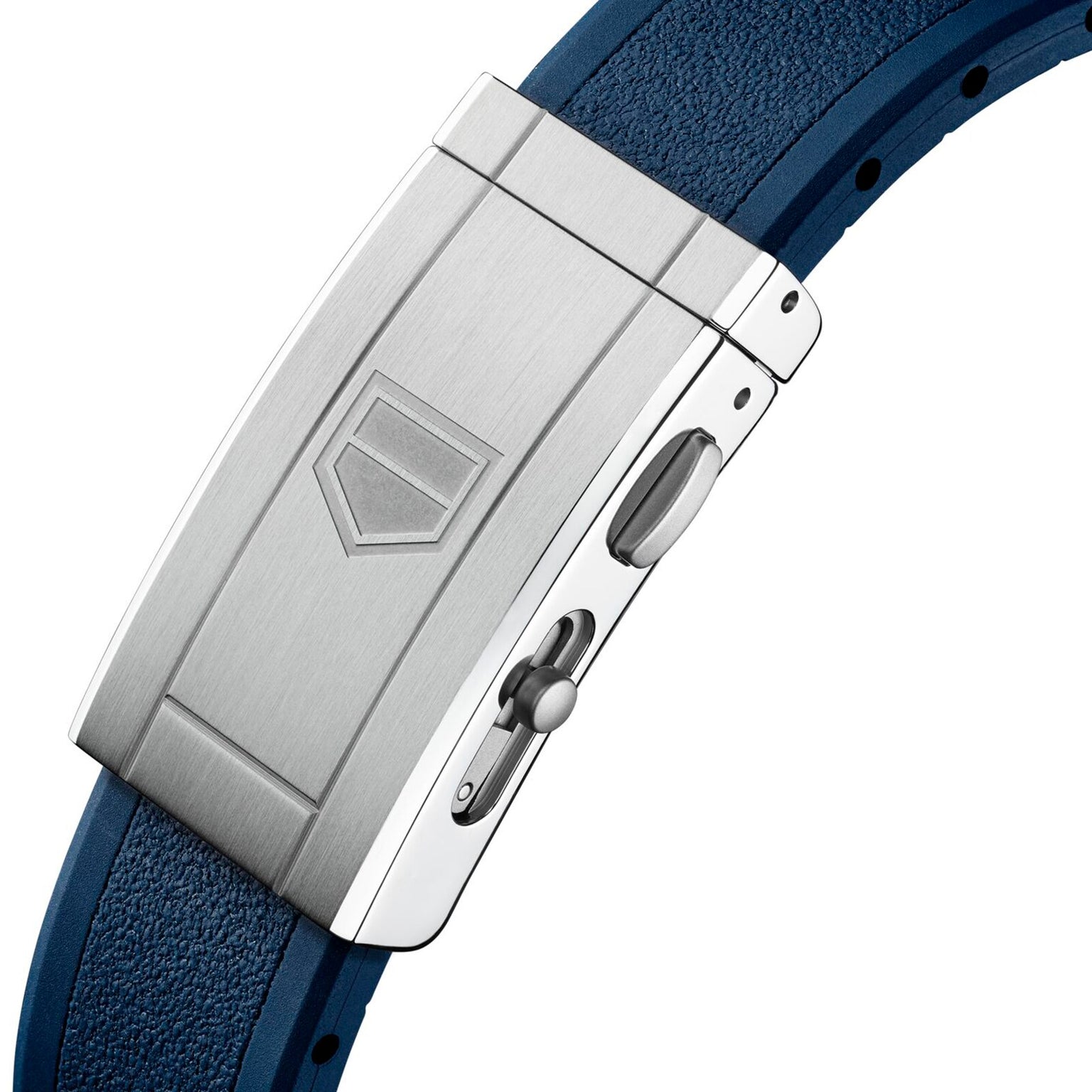 Close-up of a metallic clasp with shield engraving on the blue textured strap of the TAG Heuer Aquaracer Professional 300 GMT, highlighting its elegant adjustment mechanism—a refined detail on this luxury watch.