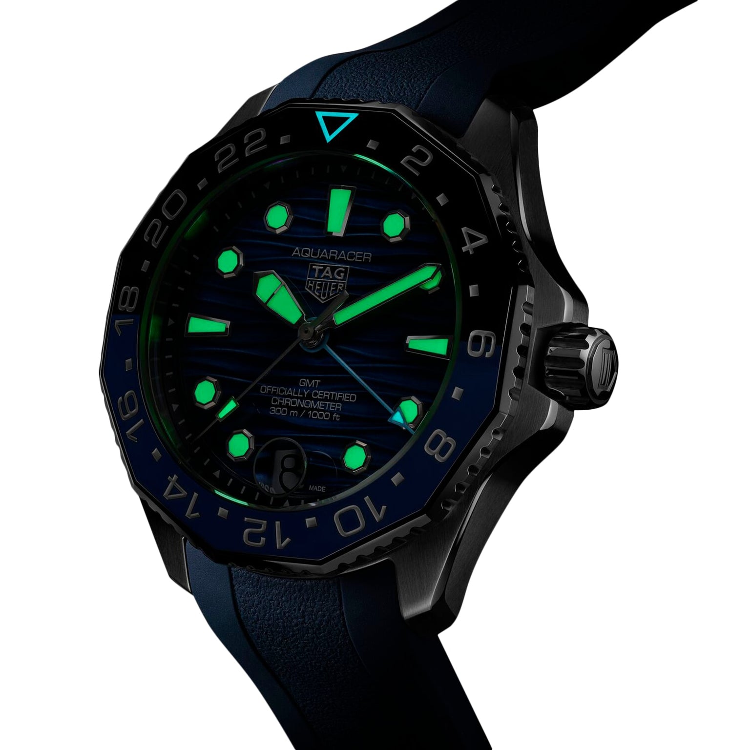 The TAG Heuer Aquaracer Professional 300 GMT features a blue dial with luminescent markers for readability in the dark, a matching blue rubber strap, and is powered by automatic movement.