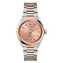 The TAG Heuer Carrera Date wristwatch features a pink dial, 18ct rose gold accents, a date display at 6 o’clock, and a two-tone stainless steel and rose gold bracelet.