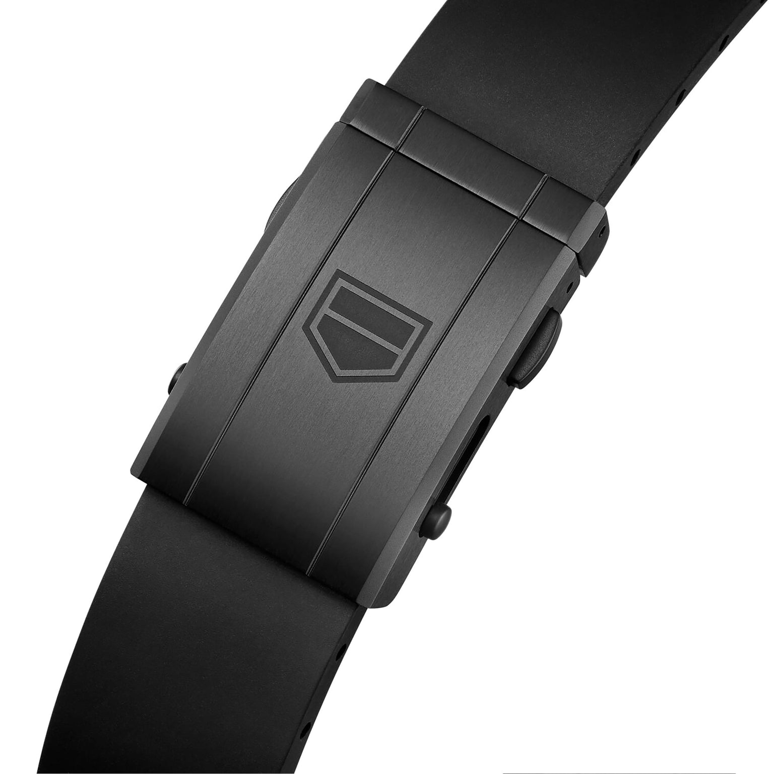 Close-up of a matte black clasp engraved with the Carrera Chronograph Extreme Sport’s geometric logo, attached to a black rubber strap—showcasing TAG Heuer’s motorsport-inspired design.