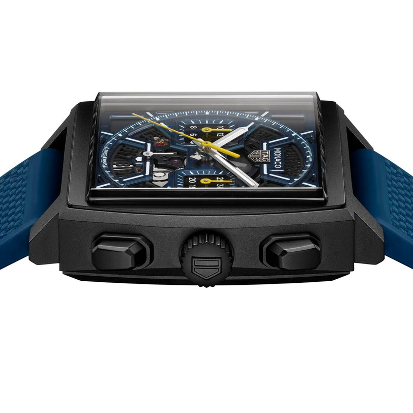 Close-up of the TAG Heuer Monaco Chronograph, showcasing its distinctive square case, blue strap, and detailed blue-and-yellow chronograph dial.