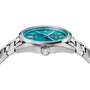 A close-up side view of the TAG Heuer Carrera Date wristwatch with a teal face, silver hour markers, and a metal link band, featuring calibre 7 automatic movement inspired by the legendary Panamericana race.
