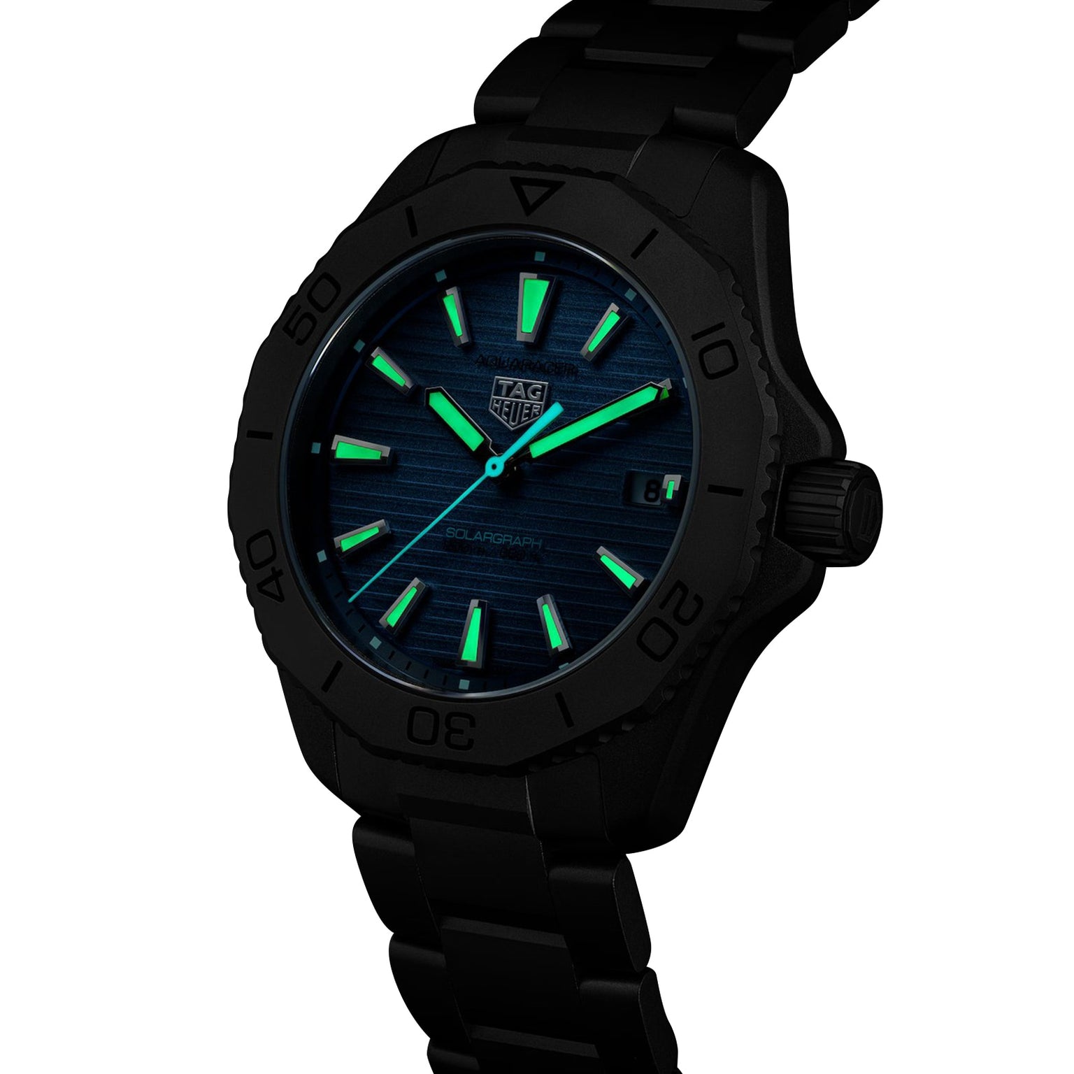 TAG Heuer Aquaracer Professional 200 Solargraph wristwatch featuring glowing green hour markers and hands on a dark blue dial, shown at an angle.