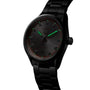 Black TAG Heuer Carrera Date wristwatch with glowing green hands and a dark dial, displayed at an angle.