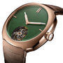A close-up of the H. Moser & Cie Streamliner Tourbillon, featuring a Wyoming jade green dial, red gold case, and a visible double hairspring flying tourbillon near 6 o’clock.