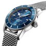 A close-up of the Breitling Superocean Heritage B20 Automatic 42, featuring a blue dial, gun blue ceramic bezel, silver hour markers, and a stainless steel mesh bracelet.