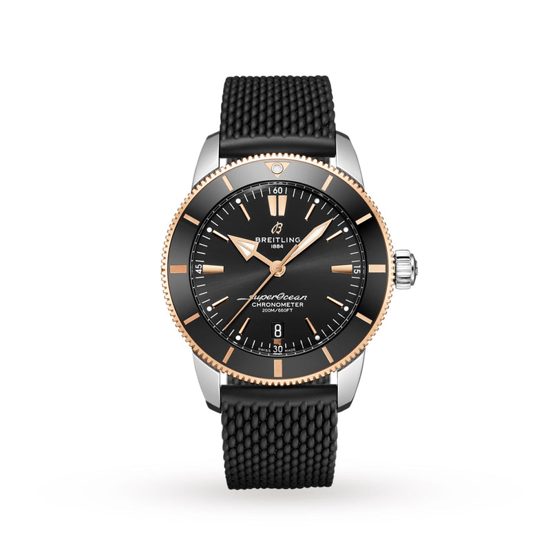 A Breitling Superocean Heritage B20 Automatic 44 wristwatch with a black dial, gold bezel, textured strap, luminescent hands, silver markers, and date at 6 o’clock is displayed against a plain white background.