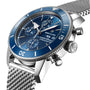 A close-up of a Breitling Superocean Heritage Chronograph 44 with a blue dial, stainless steel mesh bracelet, and three subdials powered by the Breitling 13 calibre.