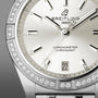 Close-up of the Breitling Chronomat Automatic 36 watch with a silver dial, diamond hour markers, date display at 6 o’clock, diamond bezel, and signature Rouleaux bracelet.