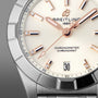 Close-up of the Breitling Chronomat 32 watch face with rose gold hands, diamond hour markers, a date display set to the 30th, and finished with the iconic Rouleaux bracelet.