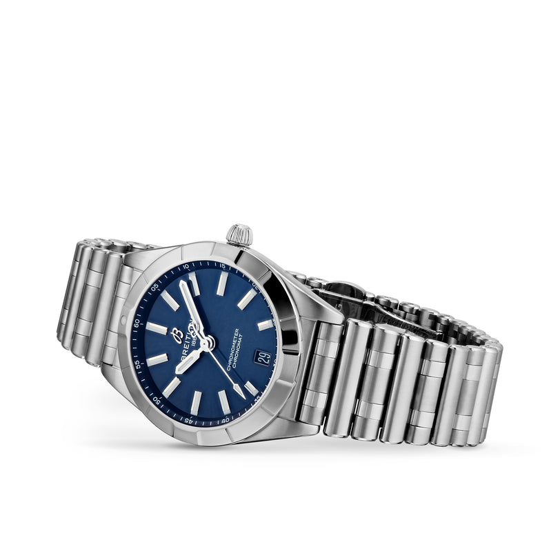 The Breitling Chronomat 32, a stainless steel wristwatch with a blue dial, silver hour markers, and date display, offers COSC-certified precision and is shown angled on a white background.