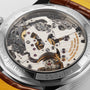 Close-up view of the exposed B09 calibre movement inside the caseback of a Breitling Premier B09 Chronograph 40, revealing gears, screws, and intricate components.