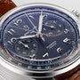 Close-up of the Breitling Premier B15 Duograph 42 with a blue dial, silver indices, chronograph subdials, brown leather strap, and COSC-certified chronometer movement.