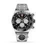 The Breitling Super Chronomat B01 44 is a stainless steel mechanical chronograph watch featuring a black bezel, three subdials, and a linked bracelet, displayed above a smaller stainless steel analog watch.