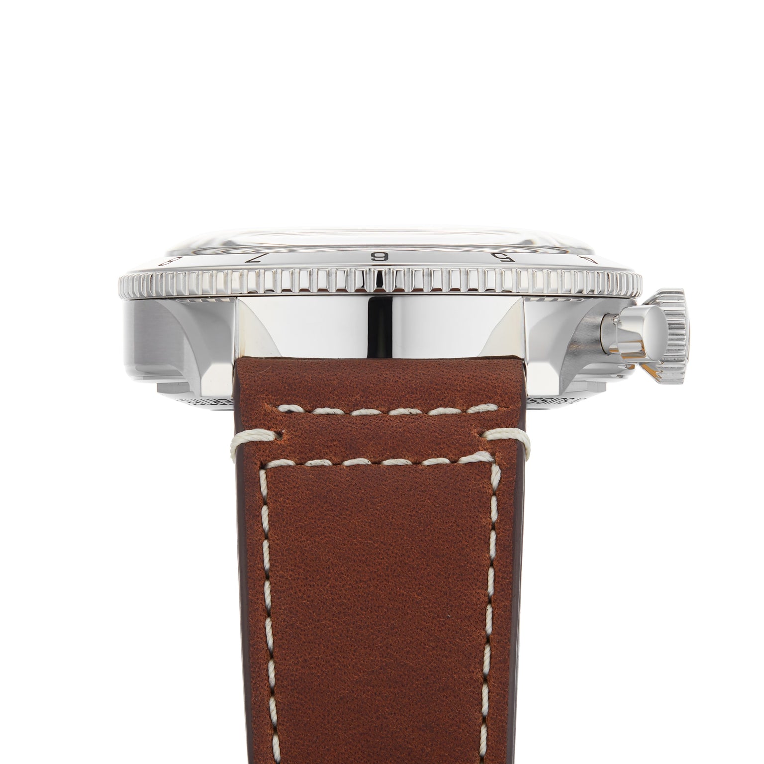 Close-up side view of the Breitling Super AVI B04 Chronograph GMT 46 Curtiss Warhawk, showcasing its stainless steel case, ridged bezel, crown, and brown leather strap with white stitching—echoing aviation heritage.