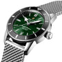 Close-up of the Breitling Superocean Heritage B20 Automatic 42 with a green dial, stainless steel case, and silver mesh bracelet.