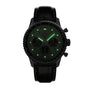 The Breitling Navitimer B01 Chronograph 43 is a black wristwatch featuring glowing green hour markers and hands, paired with a black leather strap.