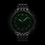 The Breitling Navitimer B01 Chronograph 46 features a COSC-certified Breitling 01 calibre, metal band, and luminous green hands and hour markers, showcased against a black background.