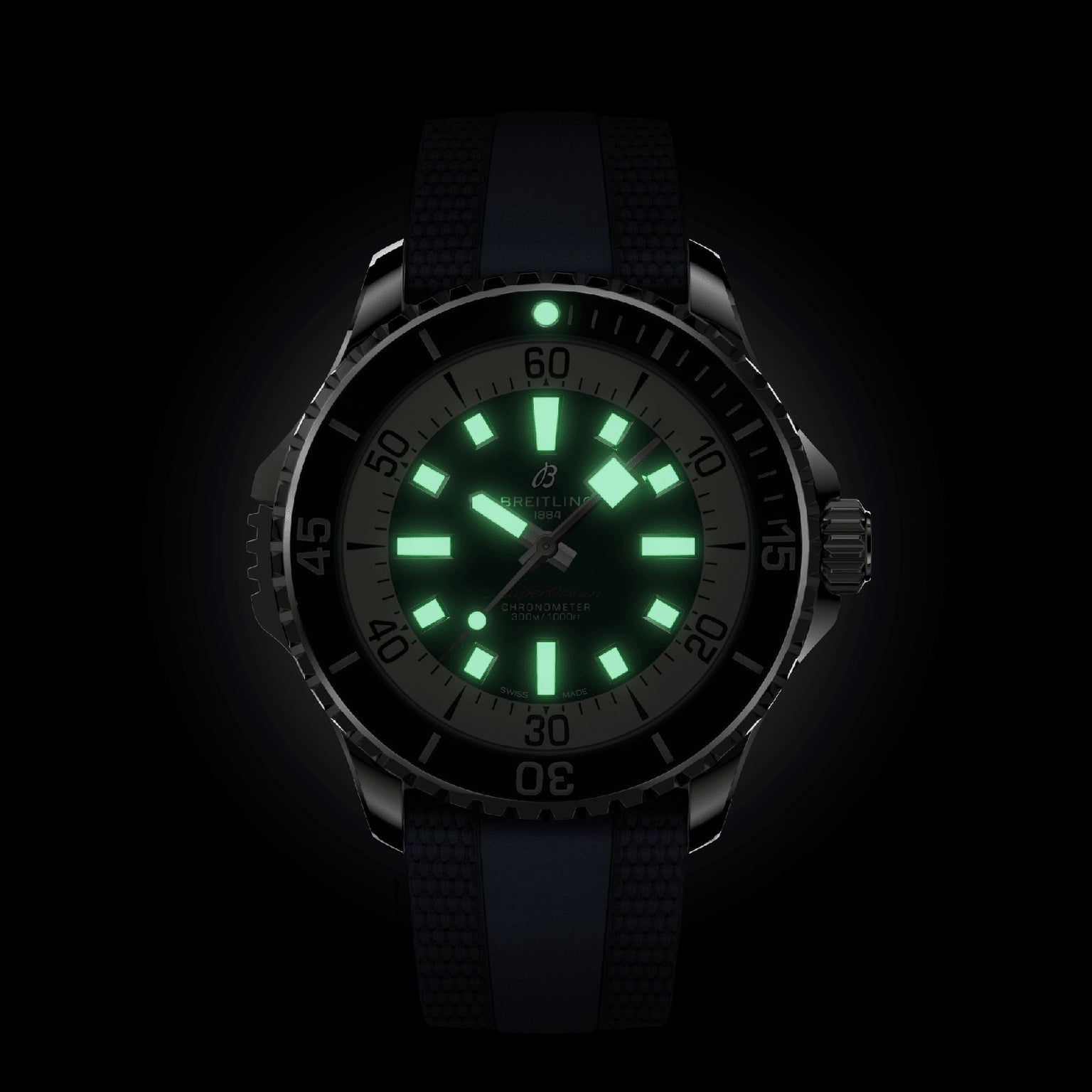 The Breitling Superocean Automatic 46 is a black wristwatch with a luminous dial and green-glowing hands set at 10:09, powered by a Breitling 17 calibre movement and designed for lasting water resistance.