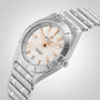 The Breitling Chronomat 32 is a stainless steel wristwatch with a silver metal band, white dial, rose gold markers and hands, diamond hour markers, and a date display at 6 o’clock, shown against a light background.