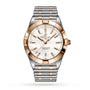 The Breitling Chronomat 32 features a silver and rose gold bracelet, white dial, gold hour markers, date display at 6 o’clock, and the Breitling logo under 12—showcasing the brand’s signature brilliance.
