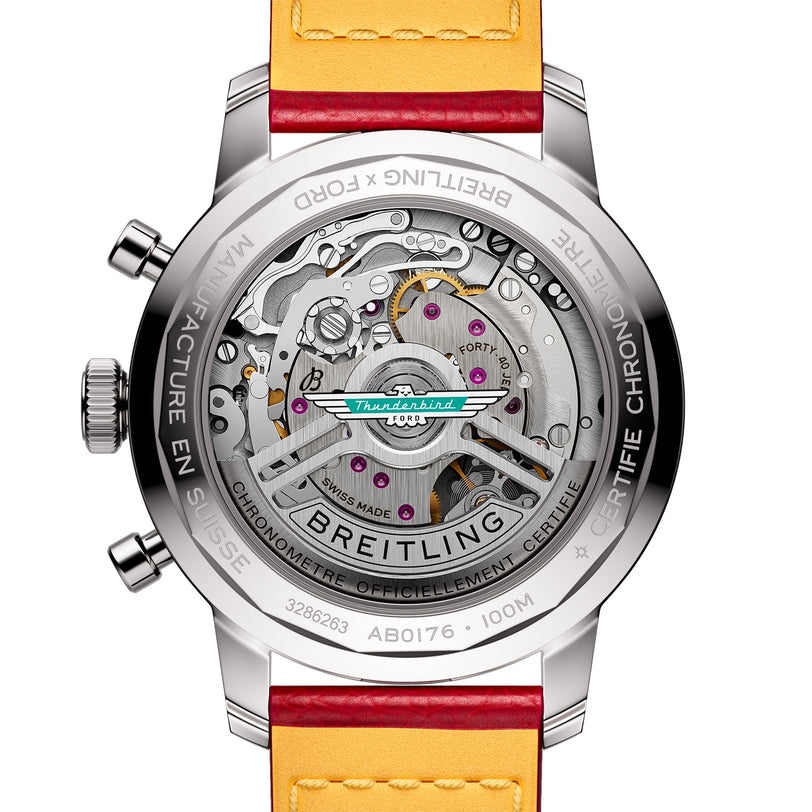 Close-up of a Breitling Top Time B01 Ford Thunderbird watch’s see-through case back, showcasing the Breitling Manufacture Calibre 01 movement, detailed engravings, and a yellow-orange leather strap.