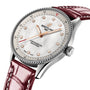 A silver Breitling Navitimer 32 watch with a diamond-studded white dial and red leather strap, powered by the Breitling Calibre 77, is displayed at an angle on a white background.
