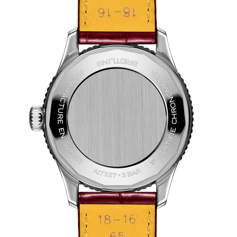 The image displays the back of a Breitling Navitimer Automatic 36, featuring a 36mm stainless steel case, leather strap, and engraved manufacturer details around the edge.