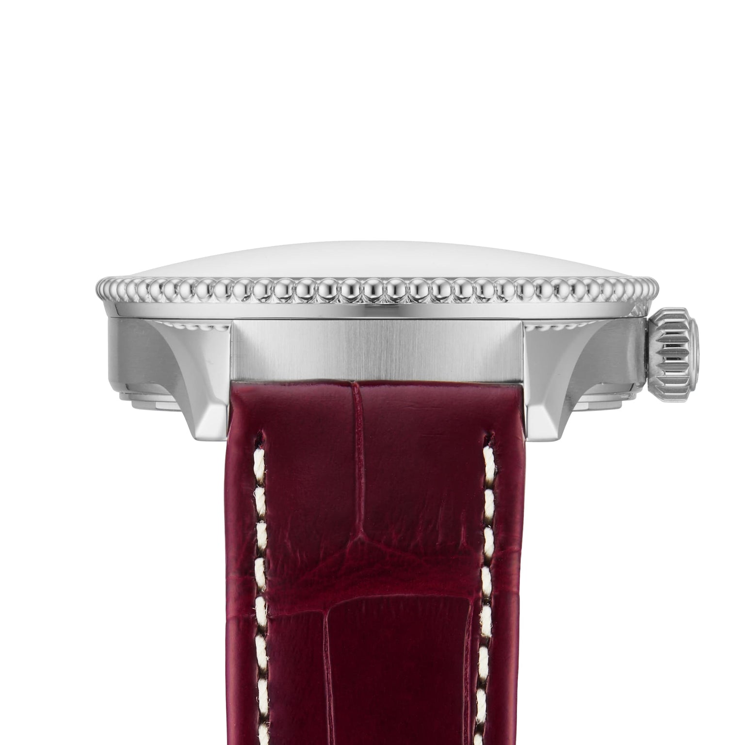 Side view of the Breitling Navitimer Automatic 36, showcasing its 36mm stainless steel case, textured bezel, ridged crown, and a dark red leather strap with white stitching.