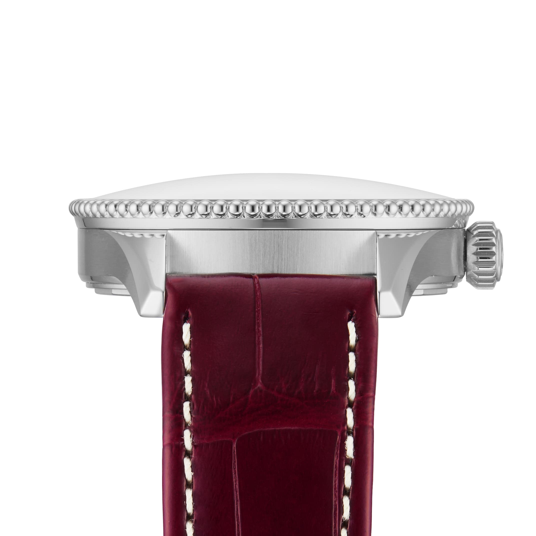 Side view of the Breitling Navitimer Automatic 36, showcasing its 36mm stainless steel case, textured bezel, ridged crown, and a dark red leather strap with white stitching.