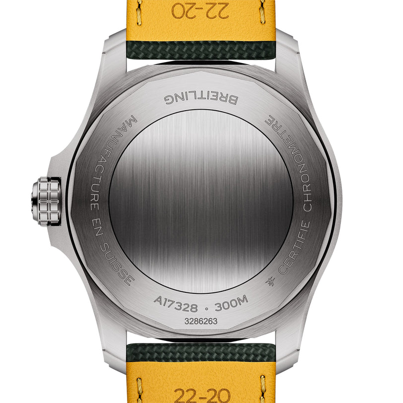 Back view of the Breitling Avenger Automatic 42 highlights its brushed stainless steel case with engraved text and a partial yellow and green military leather strap.