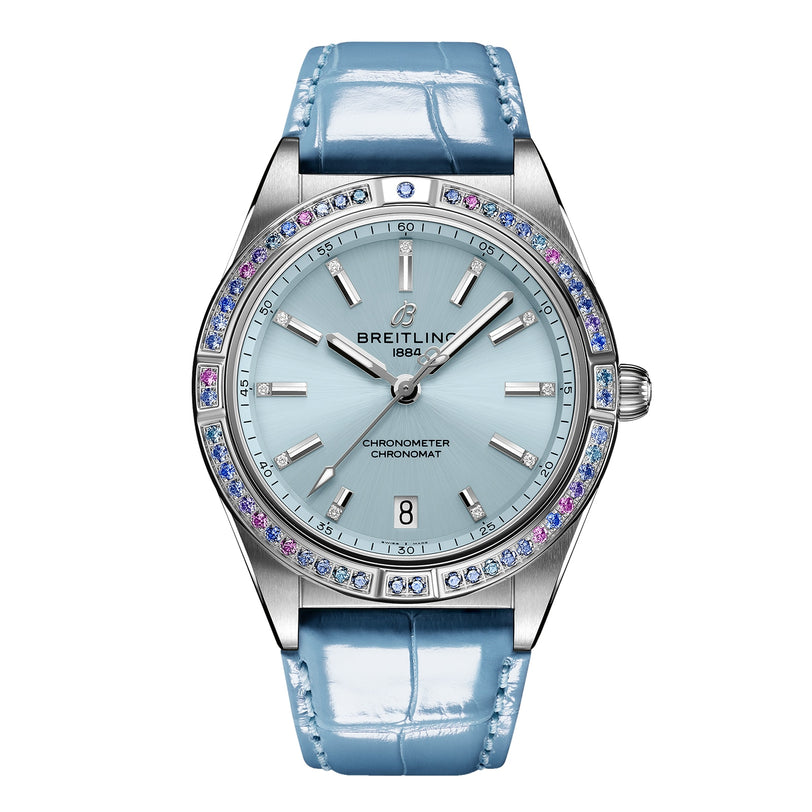 The Breitling Chronomat Automatic 36 South Sea features a light blue dial, 18K white gold gemstone bezel, silver markers, date at 6 o’clock, and a shiny light blue leather strap.