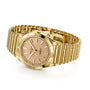 The Breitling Chronomat Automatic 36 Victoria Beckham features an 18K yellow gold case, metal link bracelet, beige dial, date at 3 o’clock, and silver markers—a stunning gold watch perfect for any occasion.