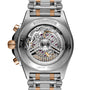 Close-up of the back of the Breitling Chronomat B01 42, revealing its exposed Breitling Manufacture 01 mechanical movement, COSC certified label, and a metal bracelet featuring silver and gold accents.