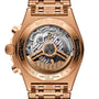 Close-up of the Breitling Chronomat B01 42 Giannis Antetokounmpos transparent case back, showcasing its intricate mechanical movement, rotor, and detailed engravings on a gold case and bracelet—part of a limited edition collection.
