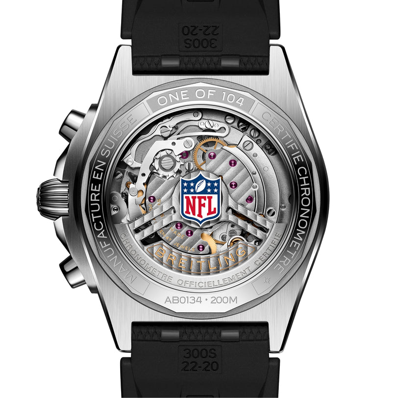 Close-up of the Breitling Chronomat B01 42 NFL Seattle Seahawks Edition watch back, showing visible gears, the NFL logo, and engraved text on the surrounding metal.