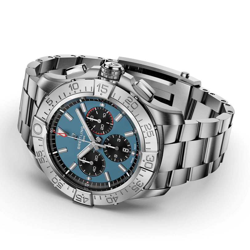The Breitling Super Avenger B01 Chronograph 46 features a stainless steel case, blue dial with three subdials, and metal bracelet, shown angled on a white background to highlight its bold aviation-inspired design.
