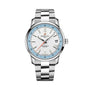 The Breitling Top Time B31 is a silver wristwatch with a white dial, blue accents, retro design, date at 3 o’clock, and a stainless steel bracelet.