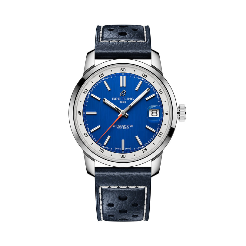 Breitling’s Top Time B31 features a blue dial, silver hour markers, date at 3 o’clock, and a perforated dark blue leather strap, blending retro style with the precise Manufacture B31 movement.