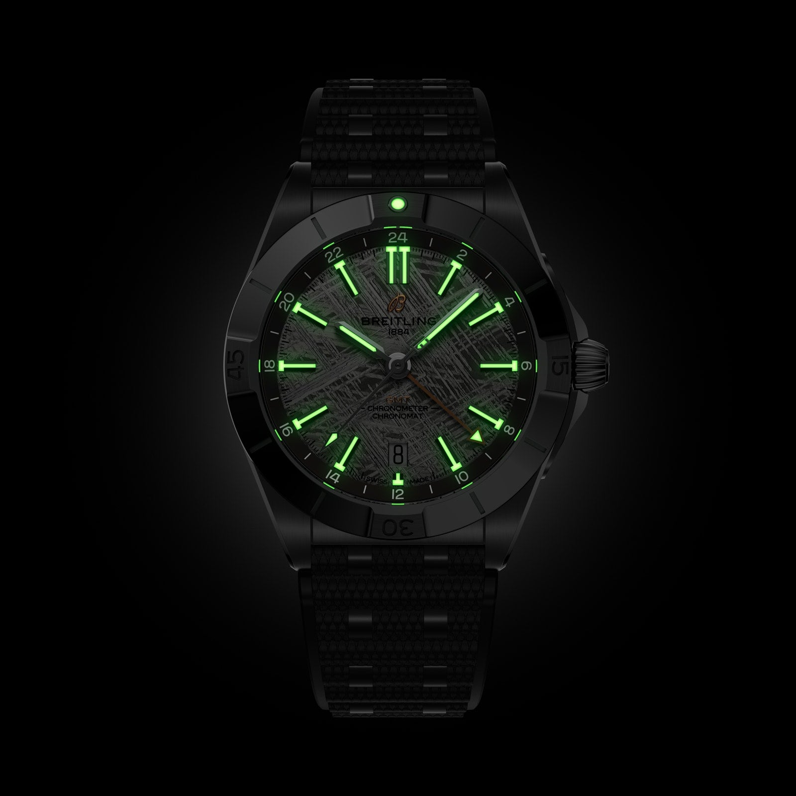 The Breitling Chronomat Automatic GMT Erling Haaland features green glowing hands and hour markers, showcased on a dark background.