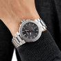 An Oris Aquis Date Relief wristwatch is worn on a person’s left wrist.
