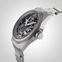 A close-up of the Oris ProPilot X Calibre 115 highlights its skeleton dial, stainless steel case and bracelet, exposed Calibre 115 movement, and labeled crown—an authentic Swiss Made mechanical watch.