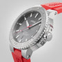 A close-up of the Oris Aquis Date Relief watch, featuring a silver bezel, black dial, and red rubber strap, highlighting its date display and water resistance features.